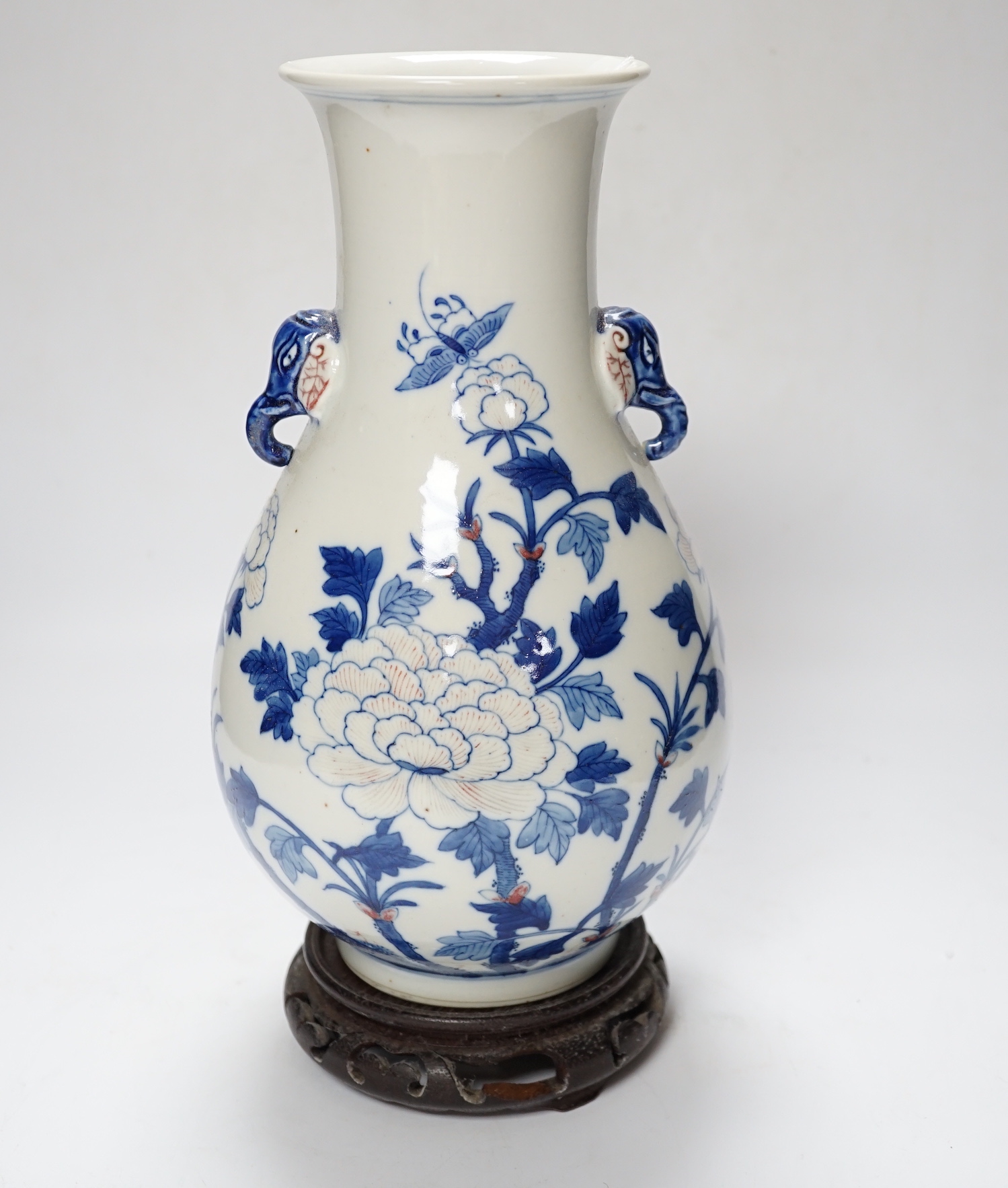 A Chinese underglaze blue and copper red pear shaped vase, on stand, 31cm high including stand